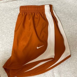 Burnt orange and white Nike dry fit shorts